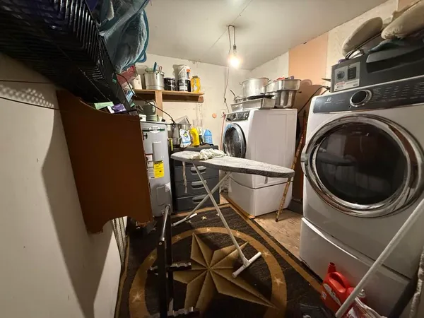 a view of a kitchen with fridge and workspace