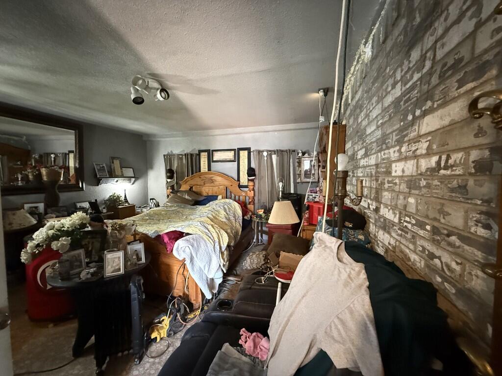 311 Northeast 3rd Seminole, TX 79360 - Photo 15 of 21 a bed room with a bed and a lamp