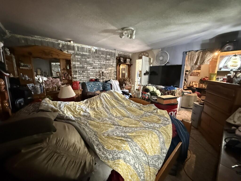 311 Northeast 3rd Seminole, TX 79360 - Photo 16 of 21 a bed room with a bed and a television