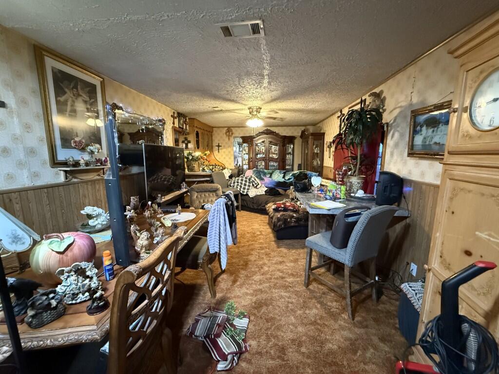 311 Northeast 3rd Seminole, TX 79360 - Photo 5 of 21 a view of a dining room with furniture and a chandelier