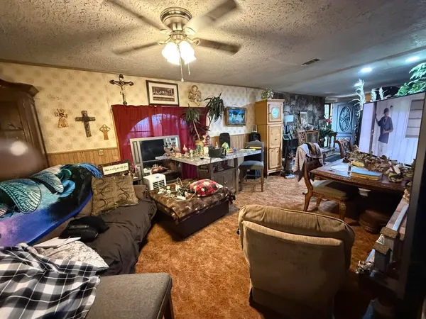 a living room with furniture and a chandelier