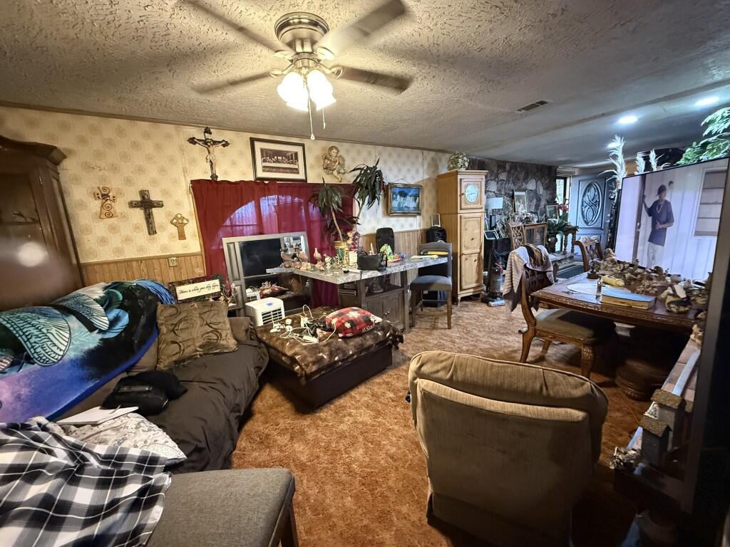 311 Northeast 3rd Seminole, TX 79360 - Photo 6 of 21 a living room with furniture and a chandelier