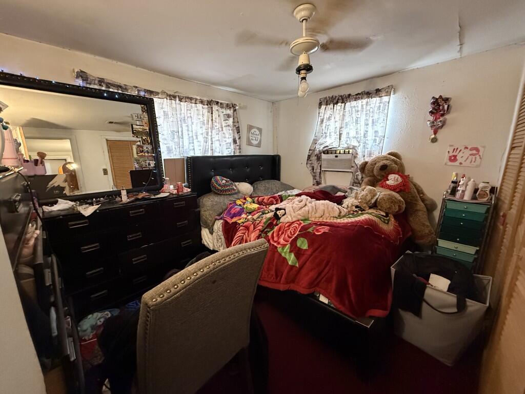 311 Northeast 3rd Seminole, TX 79360 - Photo 9 of 21 a bedroom with a bed and a window