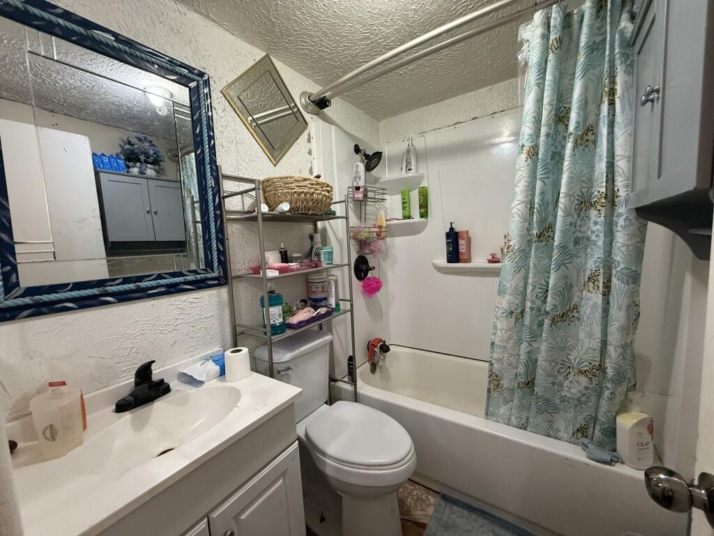 311 Northeast 3rd Seminole, TX 79360 - Photo 10 of 21 a bathroom with a sink toilet and shower