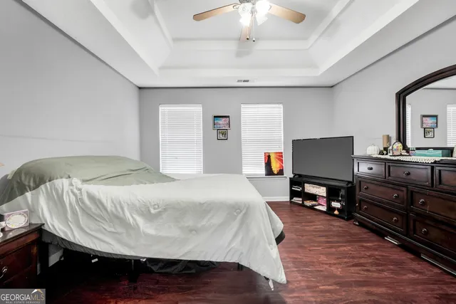 a bed room with a bed and a television