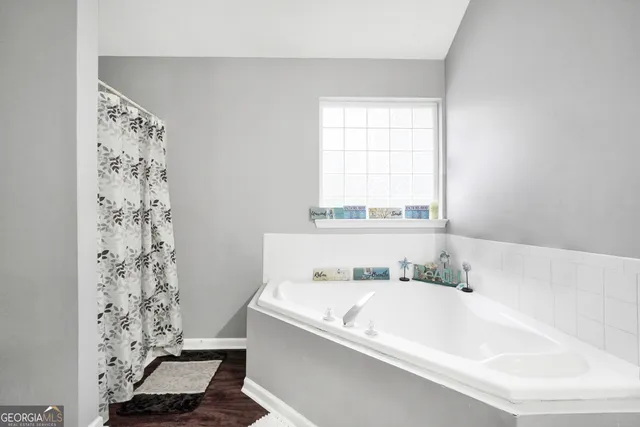 a bathroom with a bathtub and a shower