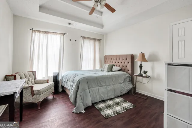 a bedroom with a bed couch and a window