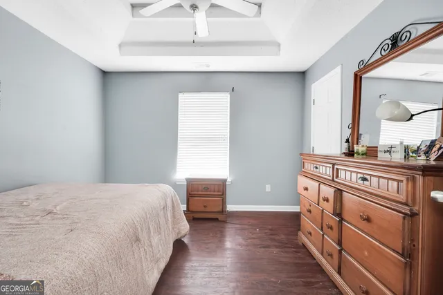 a bedroom with a bed and a dresser