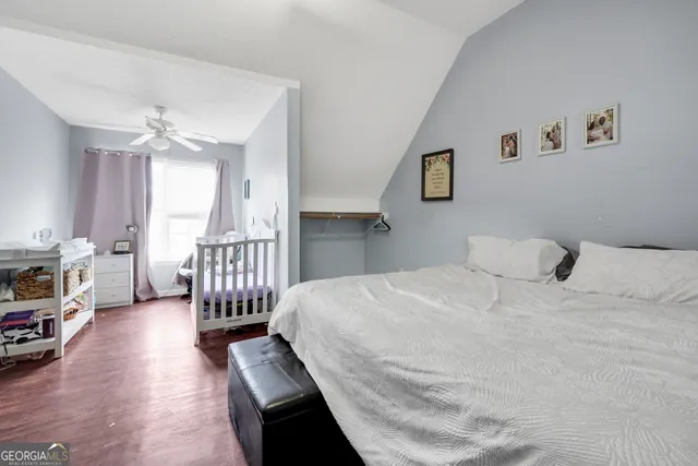 a bedroom with a bed a couch and a chandelier