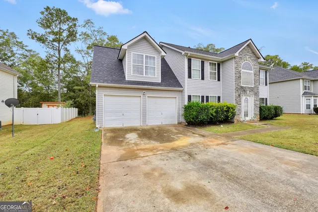 a front view of a house with a yard and garage