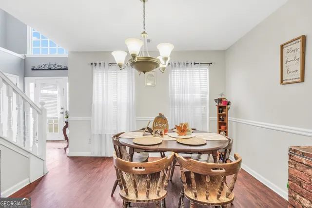 a view of a dining room with furniture wooden floor and chandelier