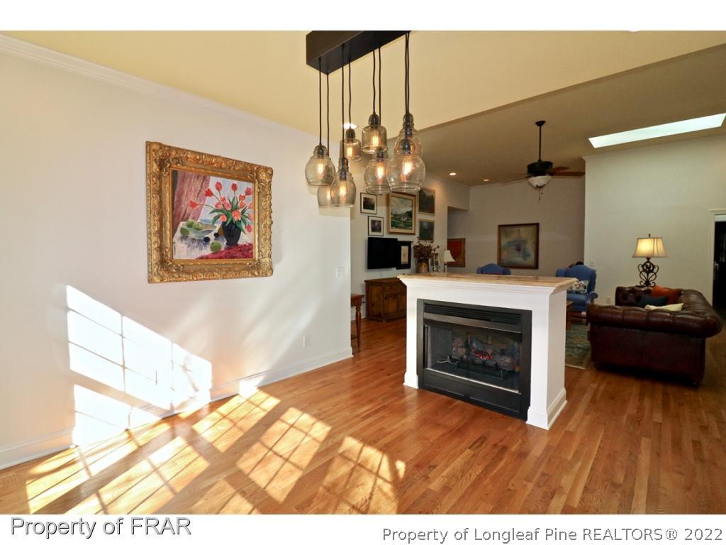 150 Lost Tree Road Pinehurst, NC 28374 - Photo 17 of 36 a living room with furniture a fireplace and a flat screen tv