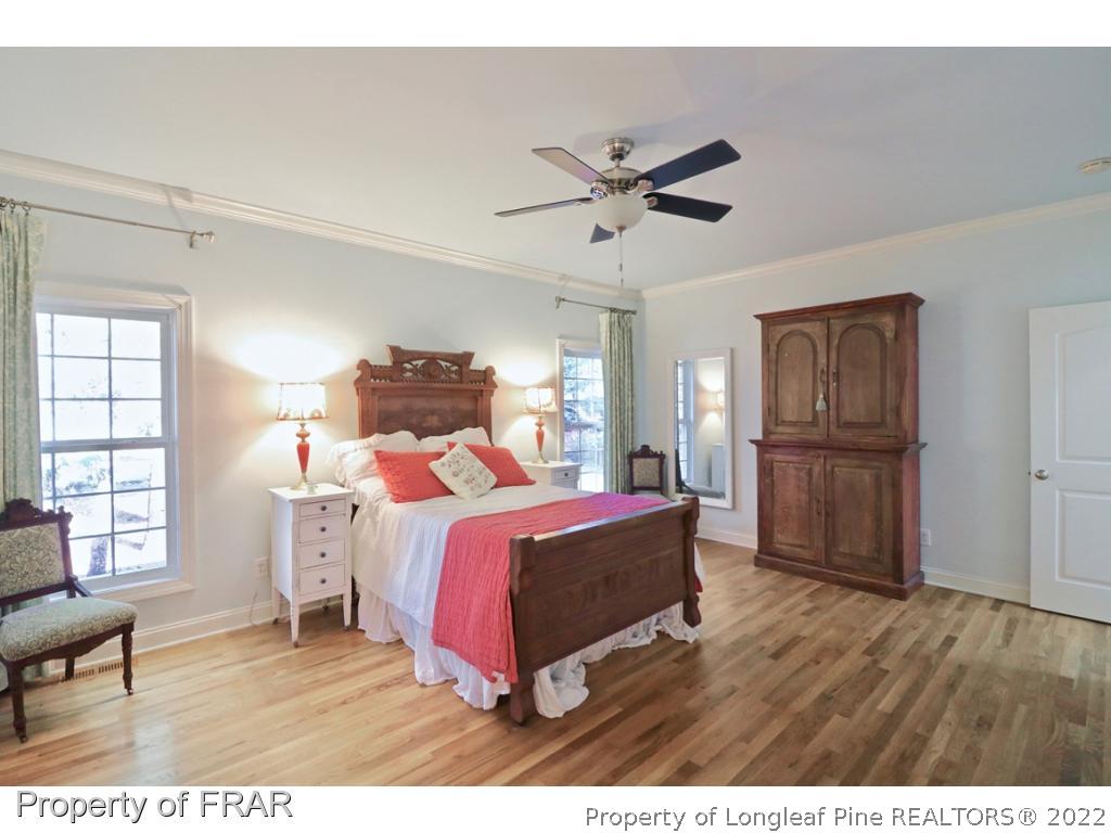 150 Lost Tree Road Pinehurst, NC 28374 - Photo 20 of 36 a bedroom with a bed and wooden floor