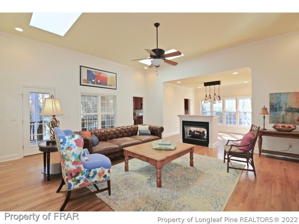 150 Lost Tree Road Pinehurst, NC 28374 - Photo 2 of 36 a living room with furniture a fireplace and a chandelier