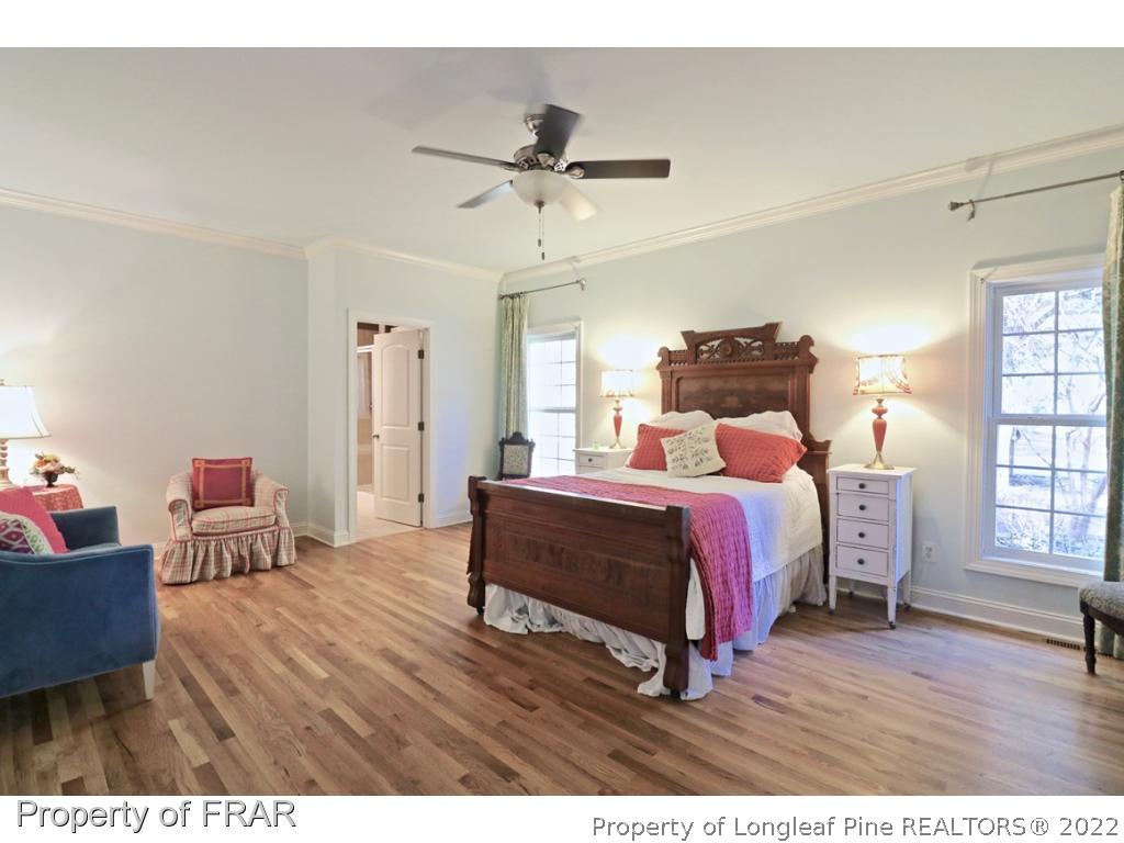 150 Lost Tree Road Pinehurst, NC 28374 - Photo 21 of 36 a bedroom with a bed and wooden floor
