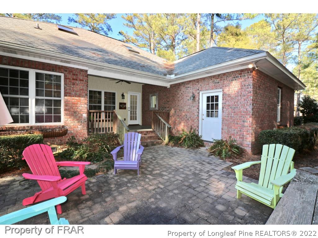 150 Lost Tree Road Pinehurst, NC 28374 - Photo 23 of 36 a view of a chair and table in backyard of the house
