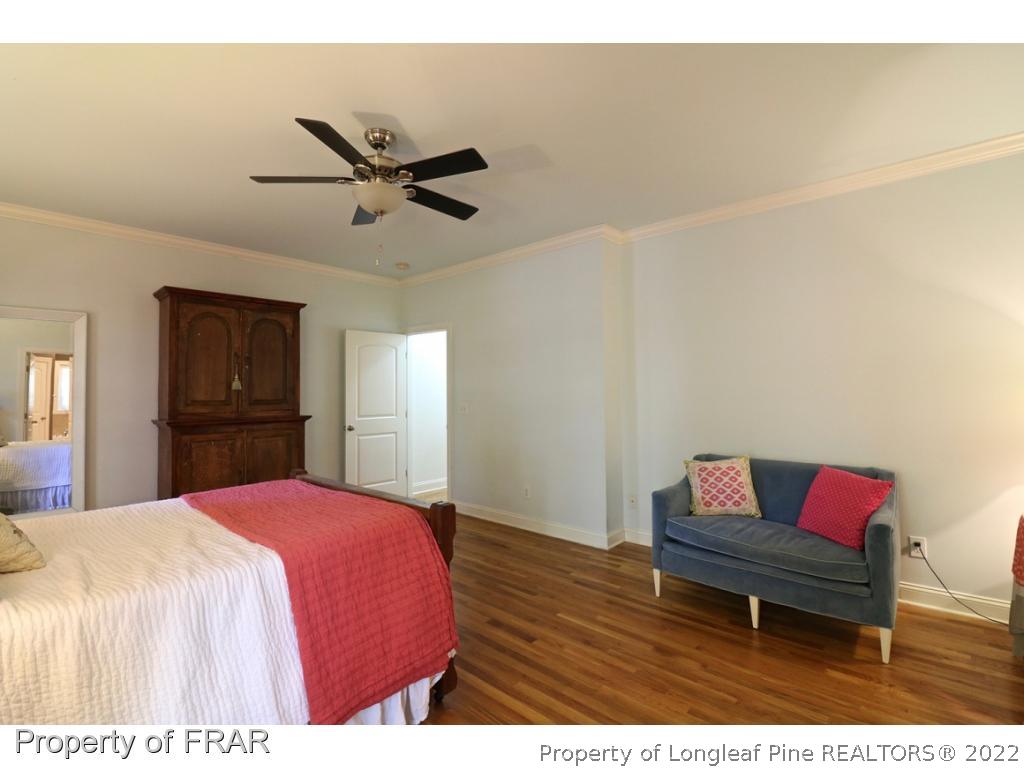 150 Lost Tree Road Pinehurst, NC 28374 - Photo 26 of 36 a bedroom with a bed and wooden floor