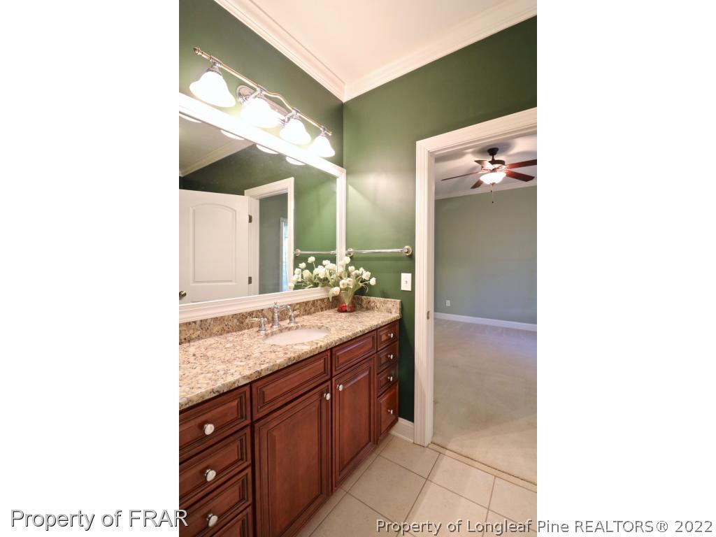 150 Lost Tree Road Pinehurst, NC 28374 - Photo 29 of 36 a bathroom with a granite countertop sink and a mirror