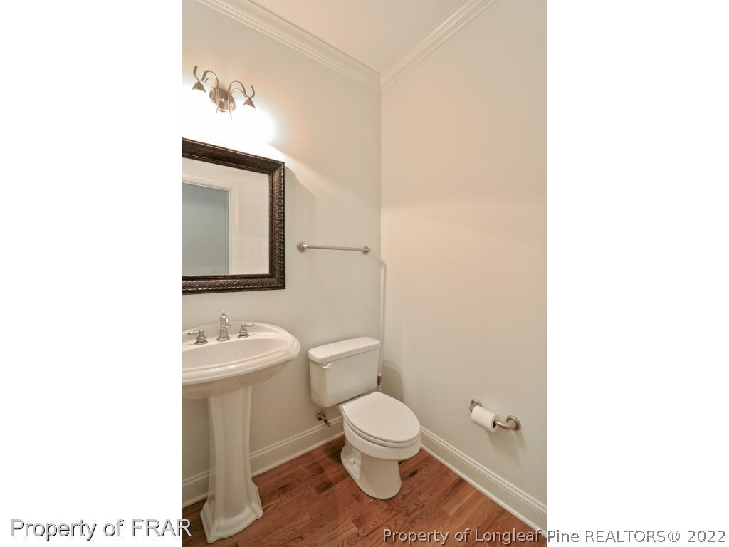 150 Lost Tree Road Pinehurst, NC 28374 - Photo 31 of 36 a bathroom with a toilet a sink and mirror