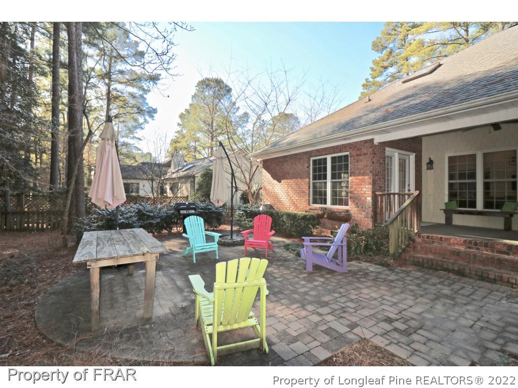 150 Lost Tree Road Pinehurst, NC 28374 - Photo 34 of 36 a backyard of a house with barbeque oven table and chairs