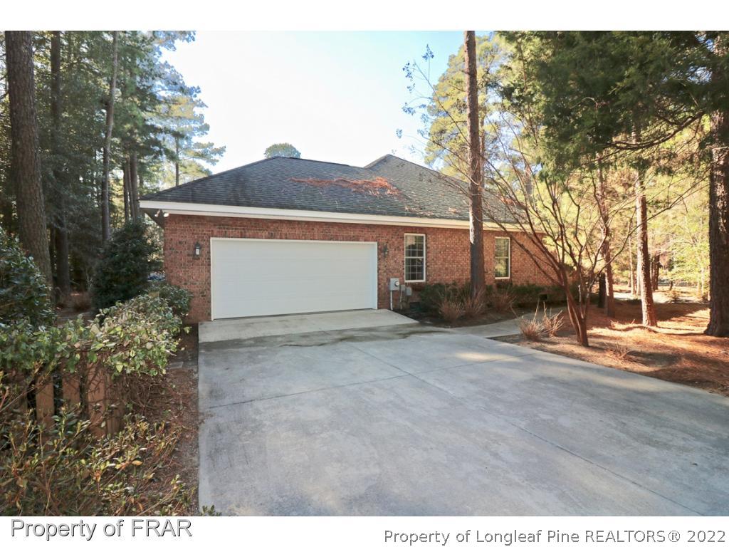 150 Lost Tree Road Pinehurst, NC 28374 - Photo 36 of 36 a view of a house with a yard and garage
