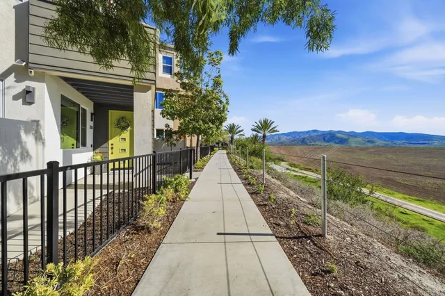a view of a pathway both side of the house
