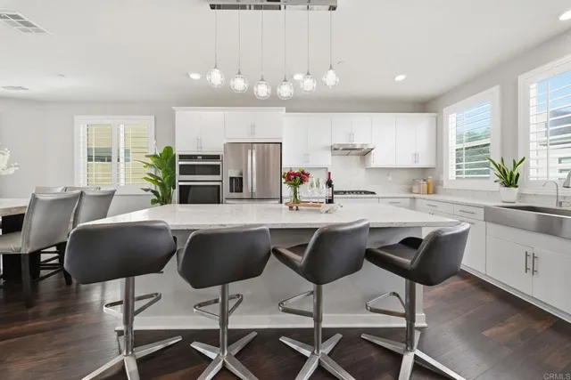 a bedroom with a large bed and a chandelier