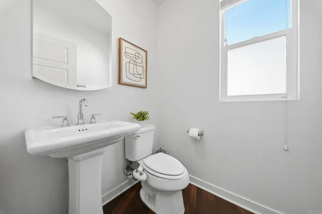 a bathroom with a toilet a sink and a window