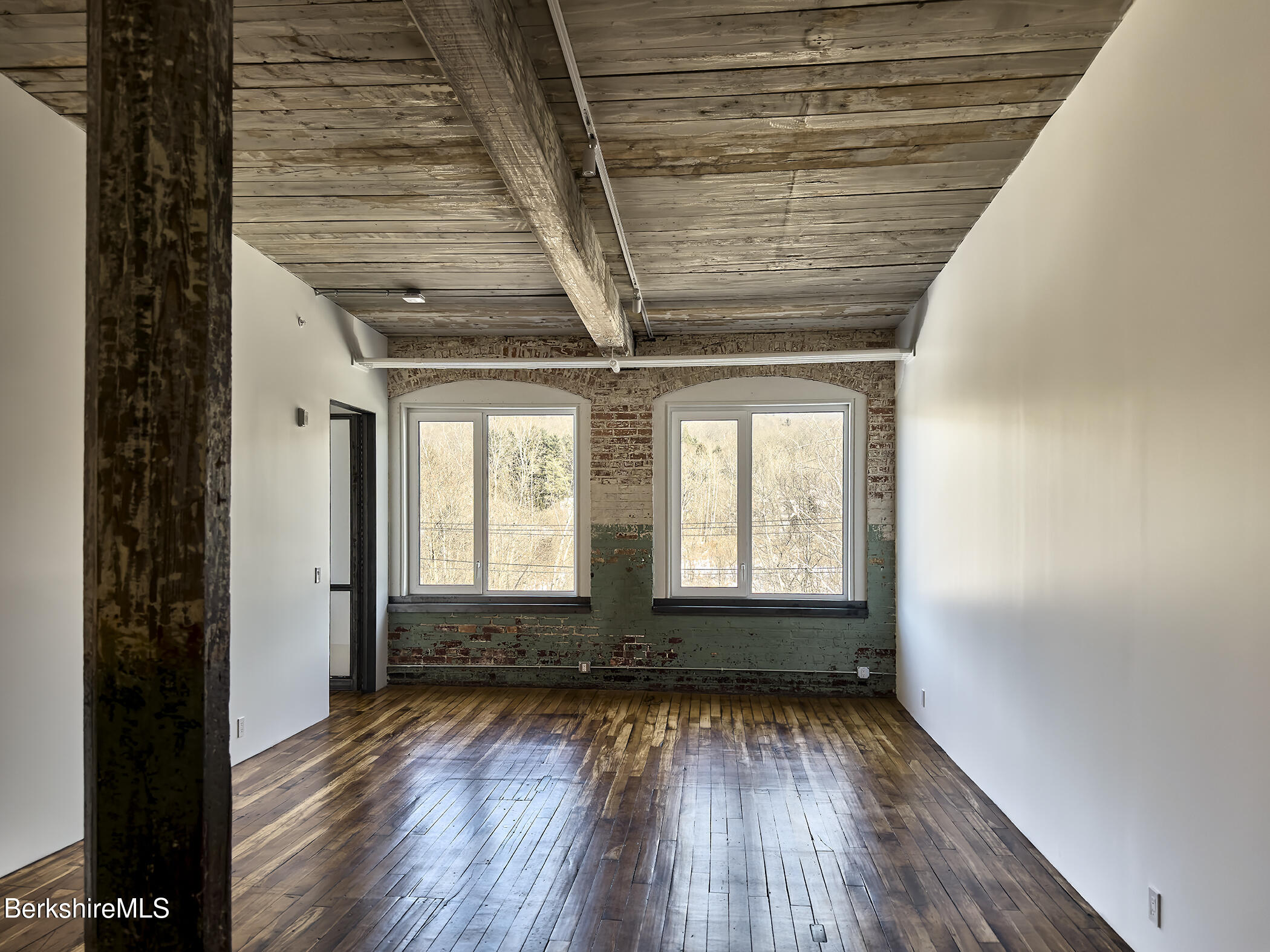 520 State Road, Unit 309 North Adams, MA 01247 - Photo 11 of 19 a view of empty room with wooden floor and fan