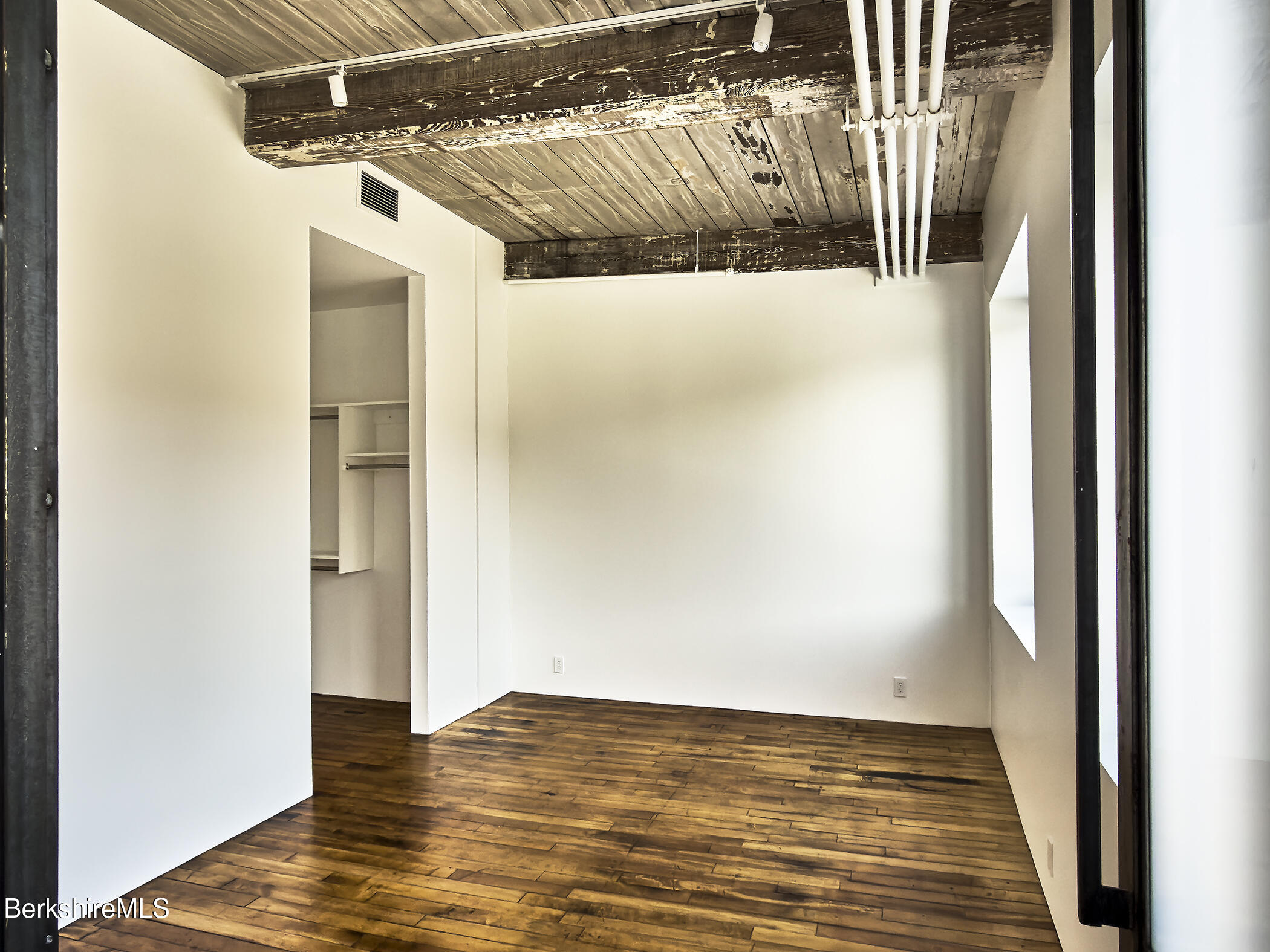 520 State Road, Unit 309 North Adams, MA 01247 - Photo 14 of 19 a view of walk in closet with wooden floor