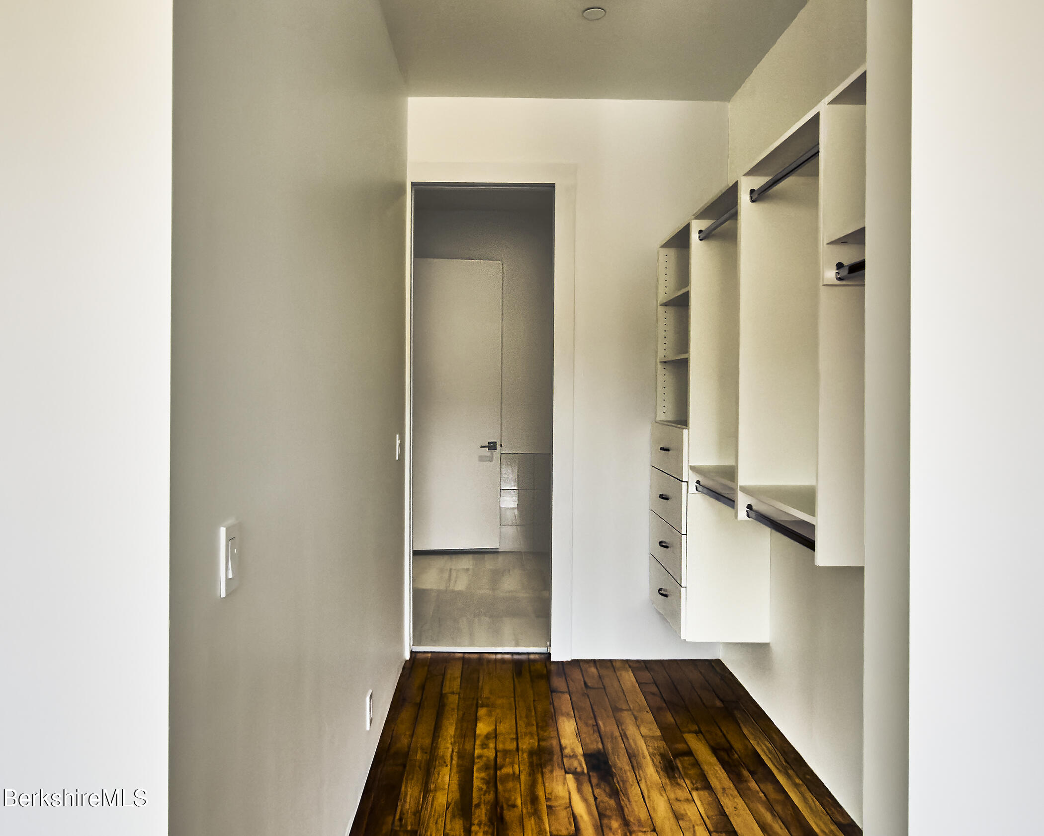 520 State Road, Unit 309 North Adams, MA 01247 - Photo 17 of 19 a view of a hallway with wooden floor and staircase