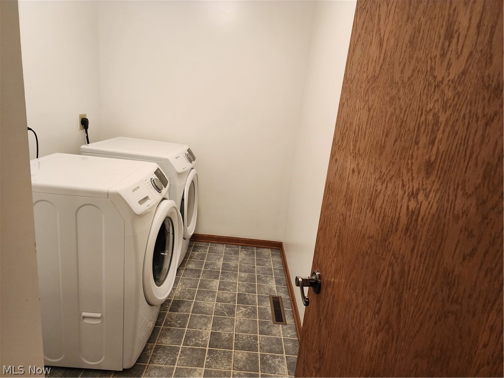 176 Overhill Road Youngstown, OH 44512 - Photo 12 of 20 Laundry room with washing machine and dryer, and dark tile flooring