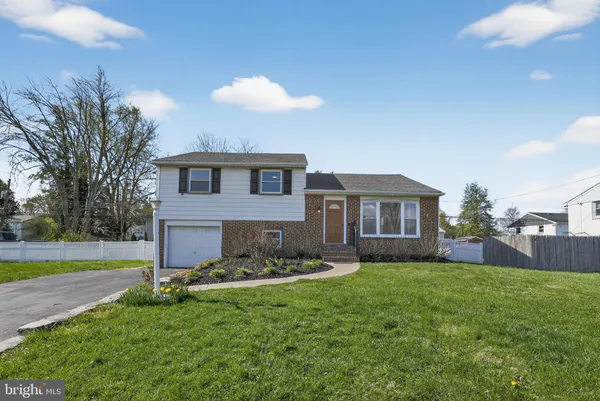 a front view of a house with a yard and a garage