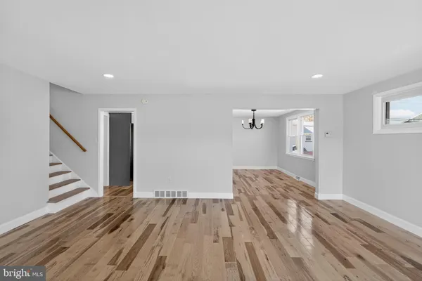 a view of a room with wooden floor and staircase