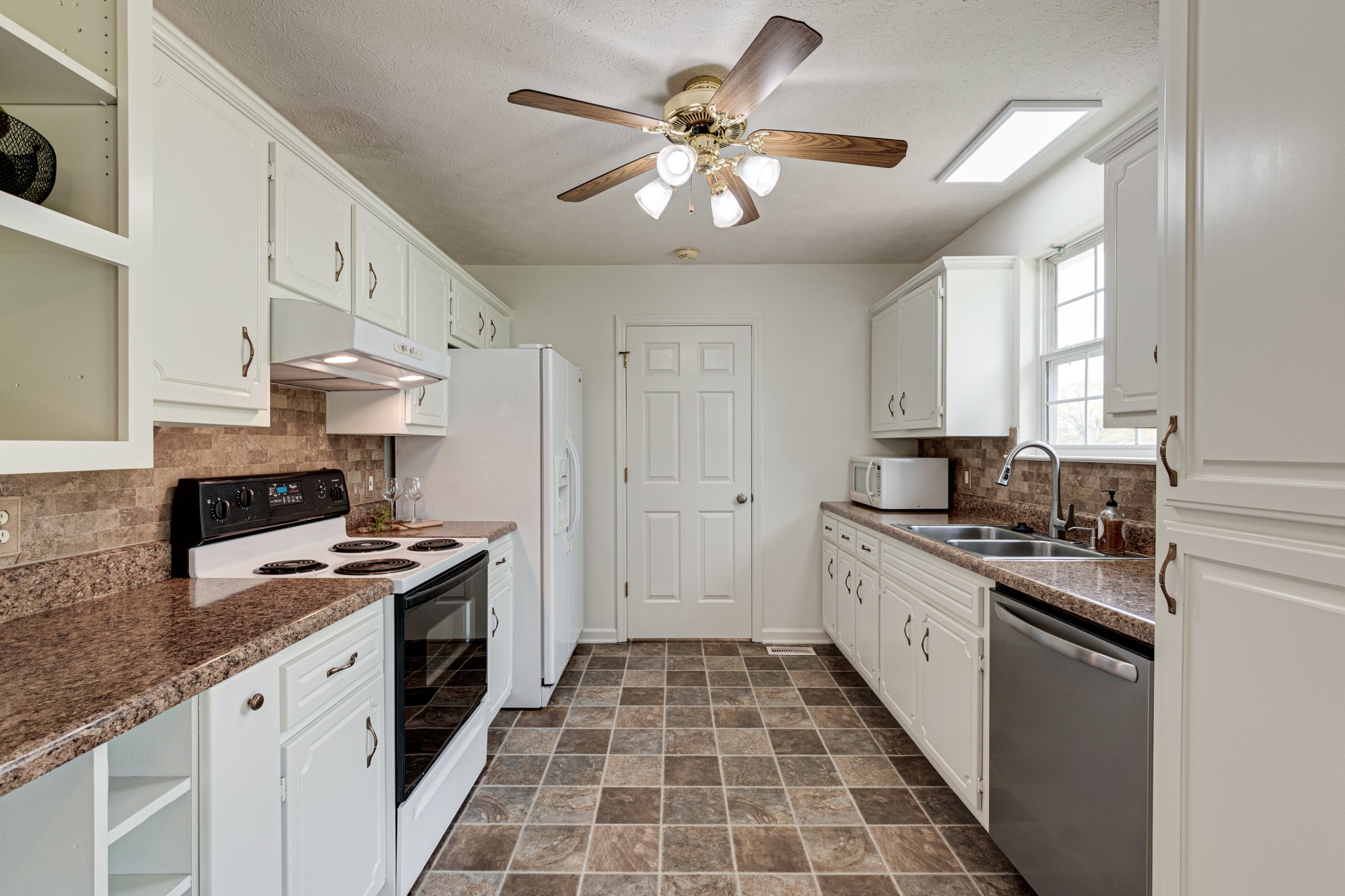 1898 Belotes Ferry Road Lebanon, TN 37087 - Photo 11 of 26 a kitchen with granite countertop stainless steel appliances a stove sink and cabinets