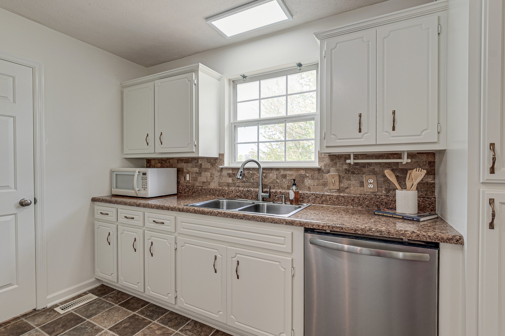 1898 Belotes Ferry Road Lebanon, TN 37087 - Photo 12 of 26 a kitchen with stainless steel appliances granite countertop a sink stove and cabinets