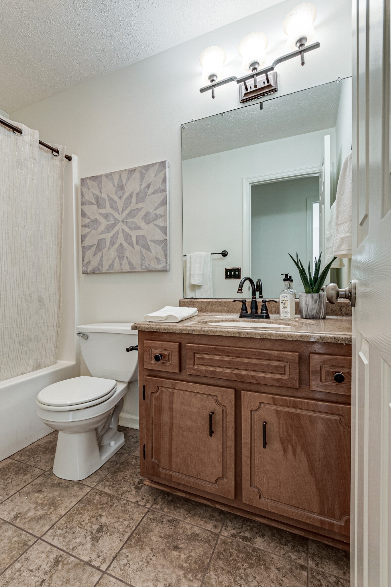 1898 Belotes Ferry Road Lebanon, TN 37087 - Photo 15 of 26 a bathroom with a toilet a sink and a mirror