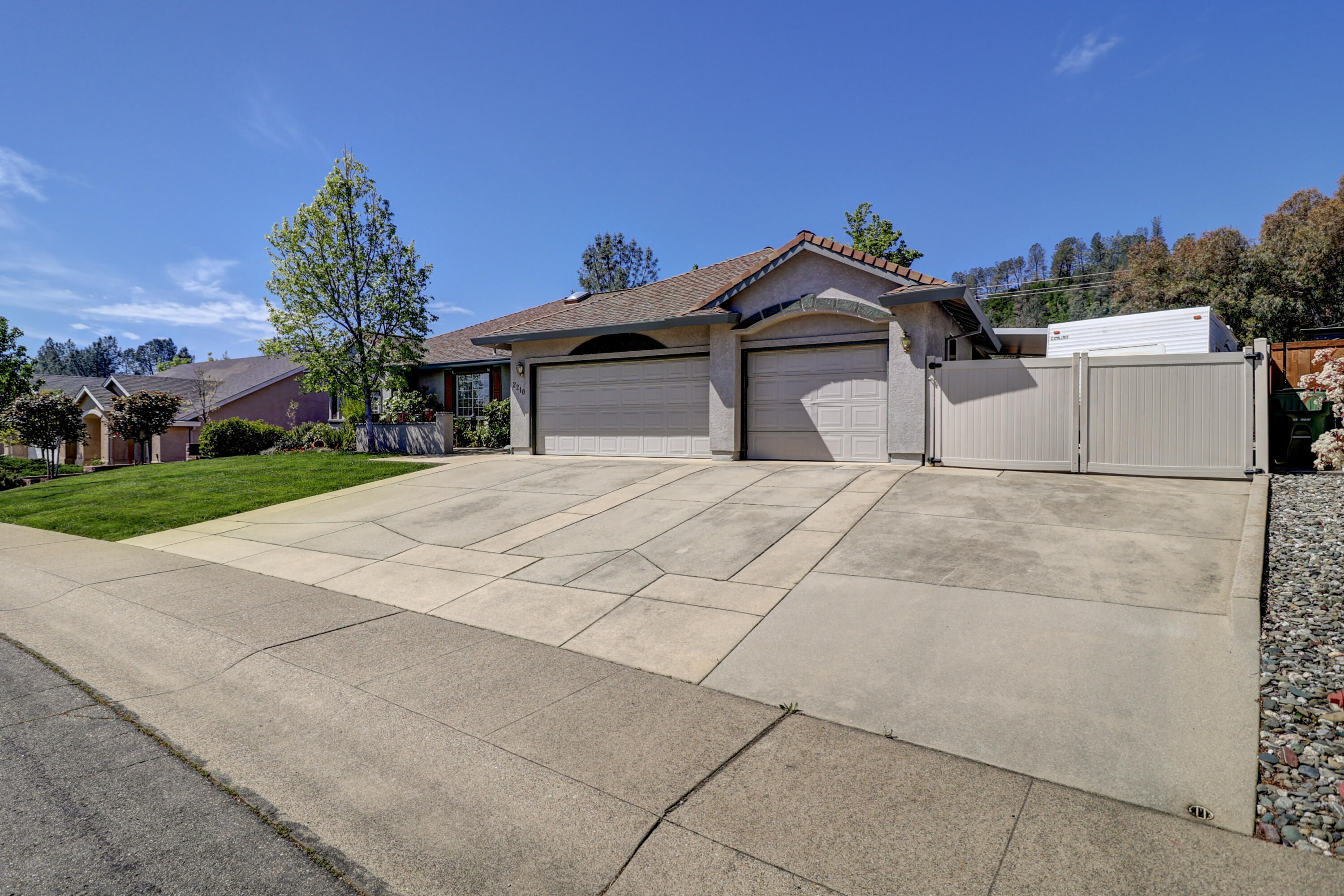2210 Drexel Way Redding, CA 96001 - Photo 2 of 57 a view of a white house with a yard and potted plants