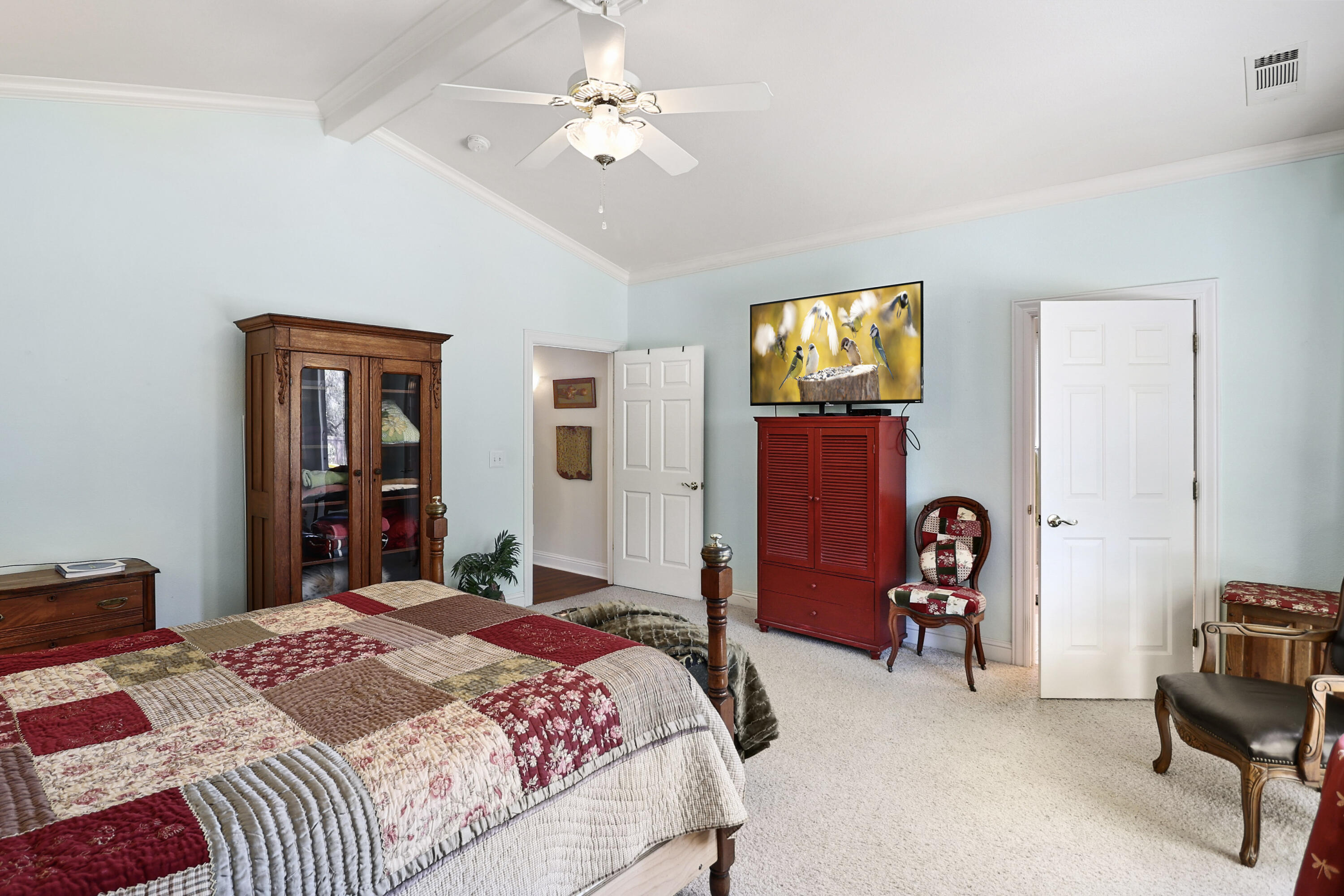 2210 Drexel Way Redding, CA 96001 - Photo 32 of 57 a bedroom with a bed and a chandelier