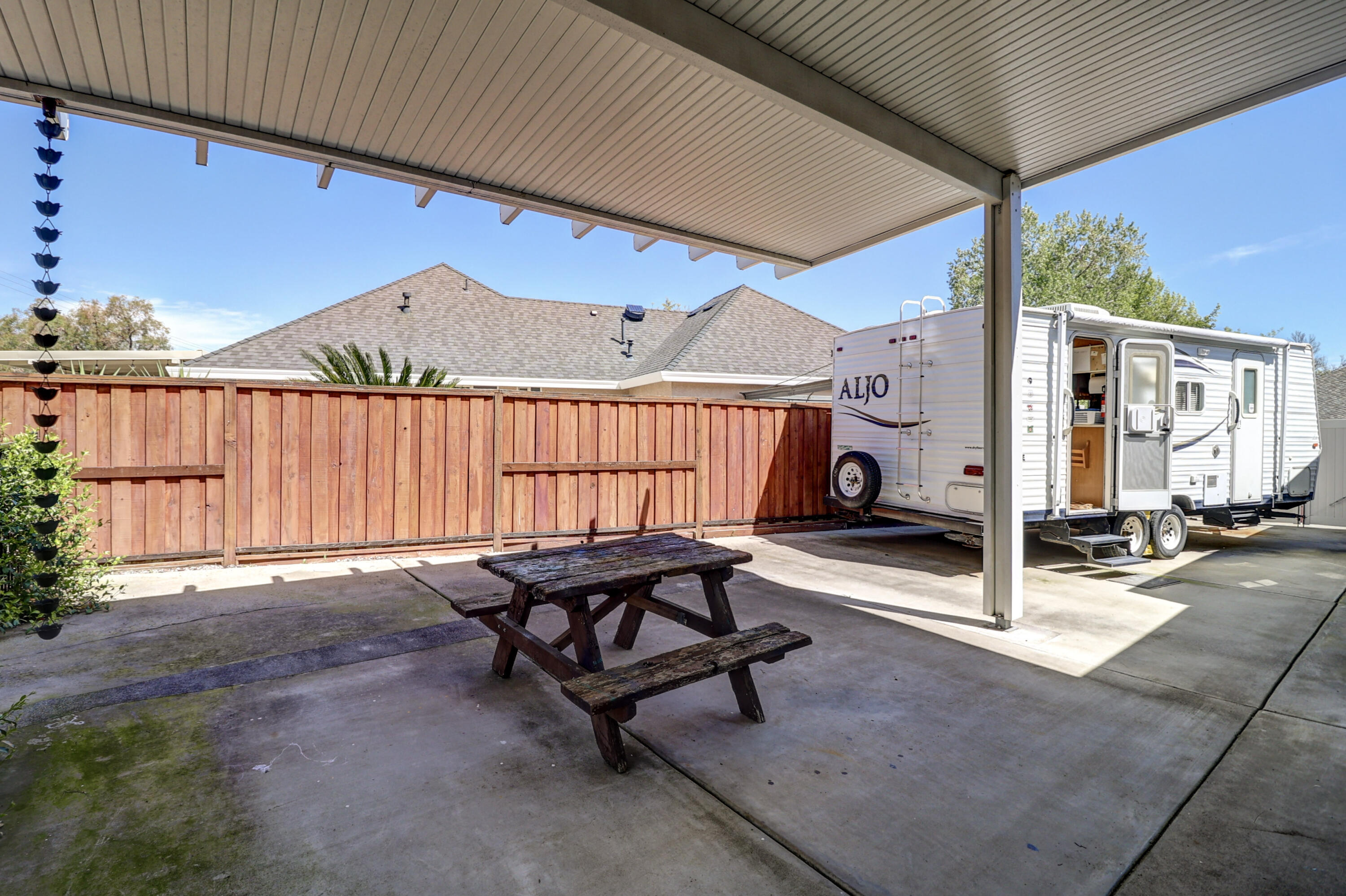 2210 Drexel Way Redding, CA 96001 - Photo 42 of 57 a view of a patio with table and chairs with wooden fence