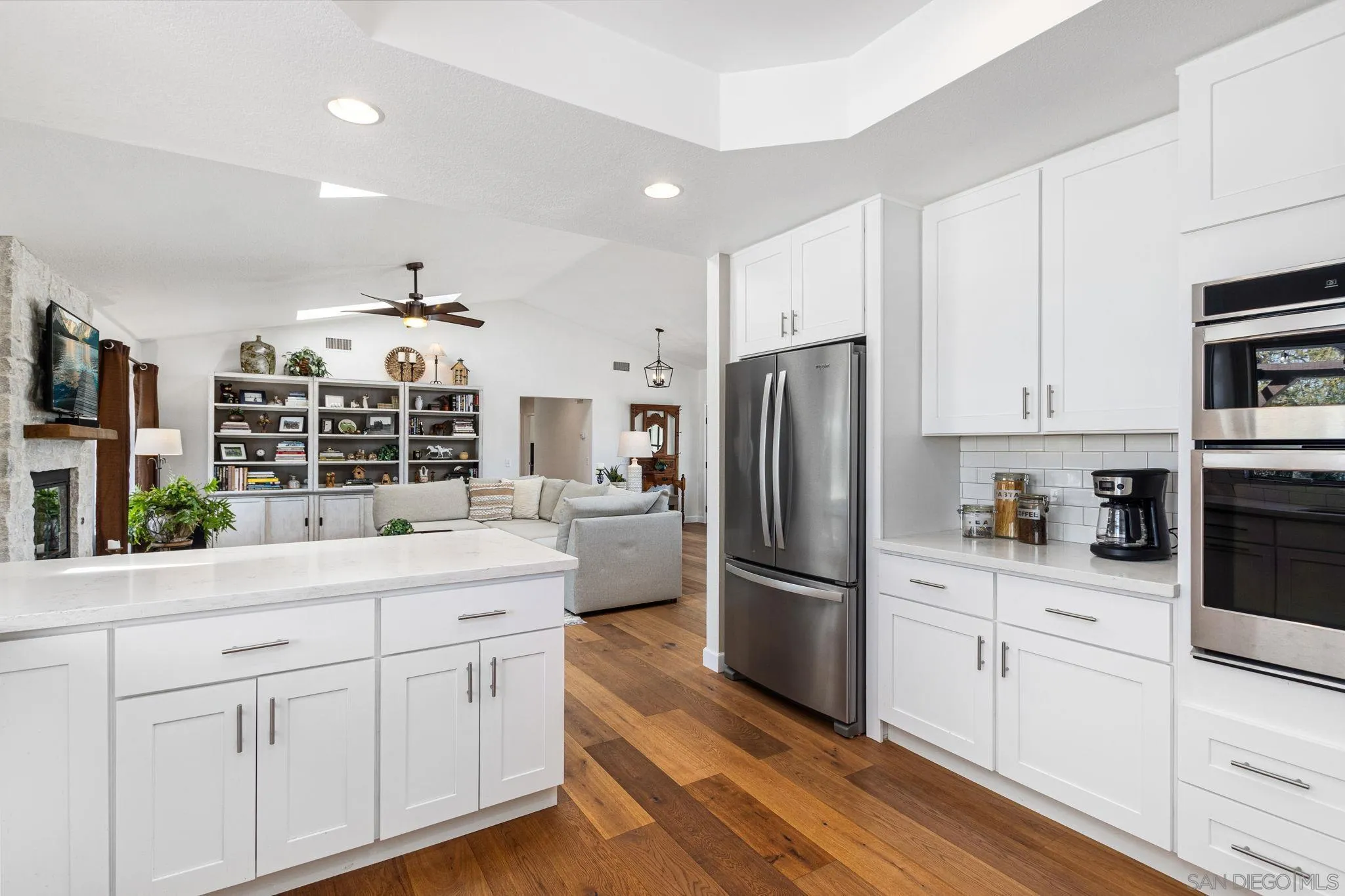 360 Futurity Lane Fallbrook, CA 92028 - Photo 14 of 58 a kitchen with white cabinets and stainless steel appliances