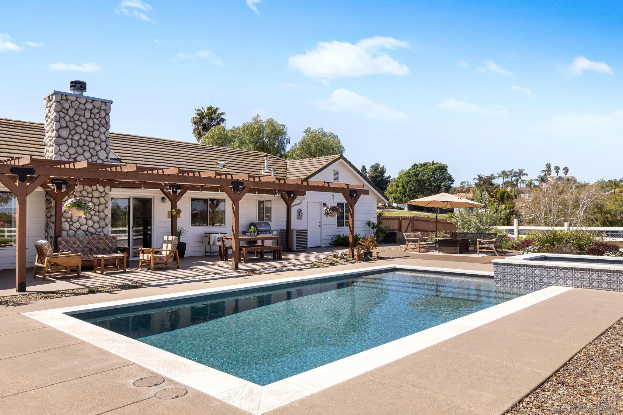 360 Futurity Lane Fallbrook, CA 92028 - Photo 33 of 58 a view of a house with pool lawn chairs and a palm tree