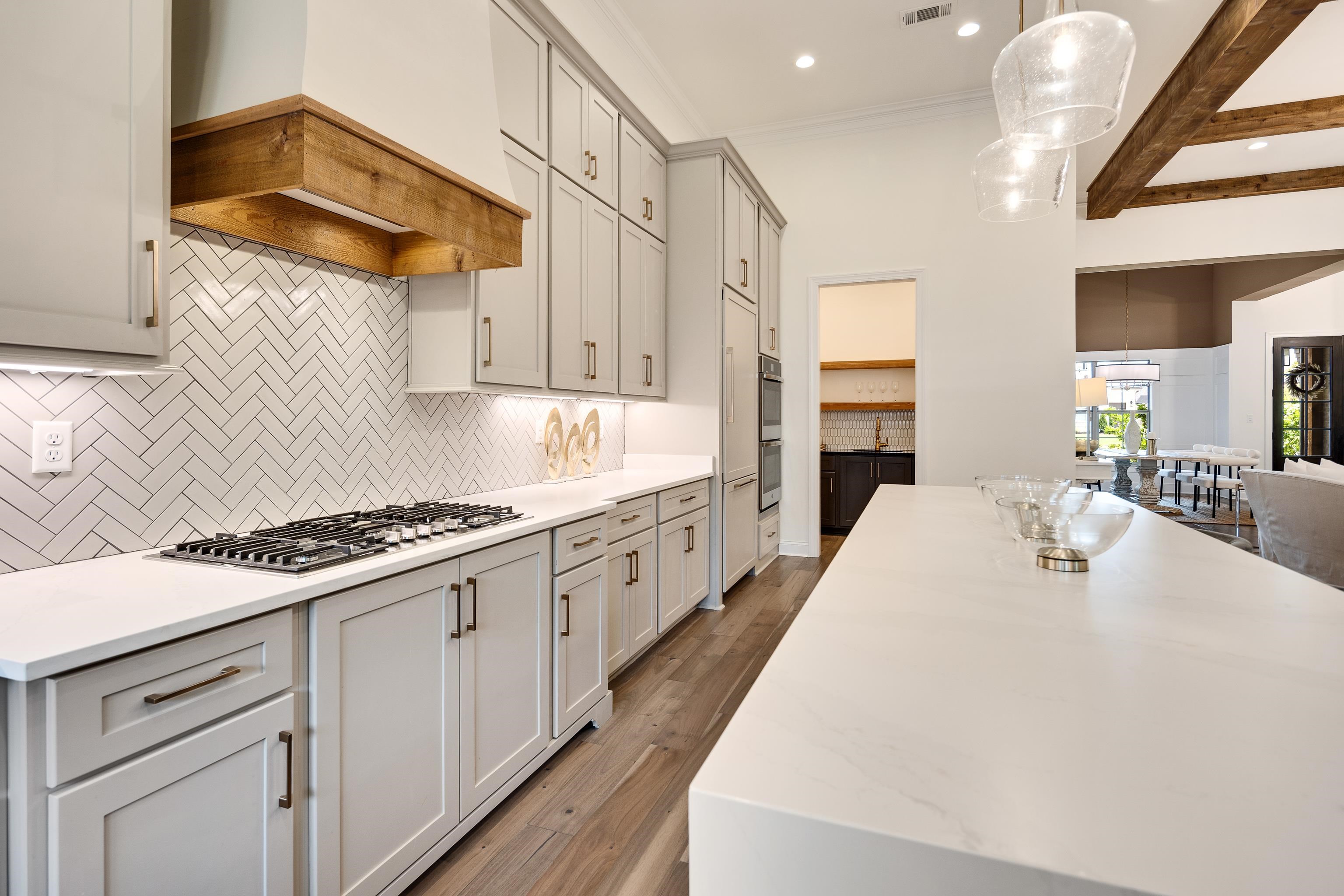 237 Beckham Drive Collierville, TN 38017 - Photo 12 of 40 Kitchen featuring stainless steel gas cooktop, custom range hood, decorative backsplash, recessed lighting, and decorative light fixtures