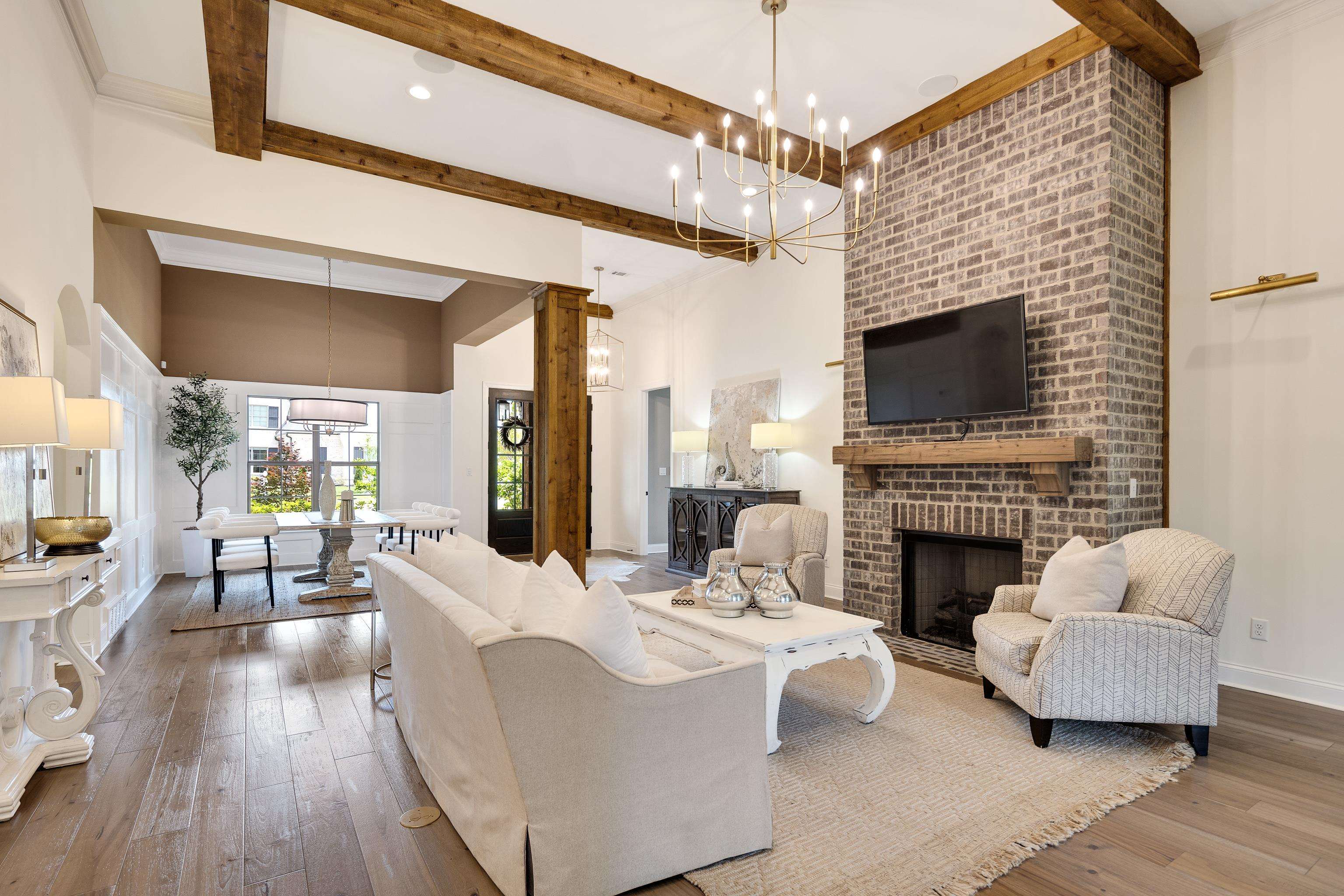 237 Beckham Drive Collierville, TN 38017 - Photo 14 of 40 Living room with beamed ceiling, hardwood / wood-style floors, a chandelier, baseboards, and a fireplace