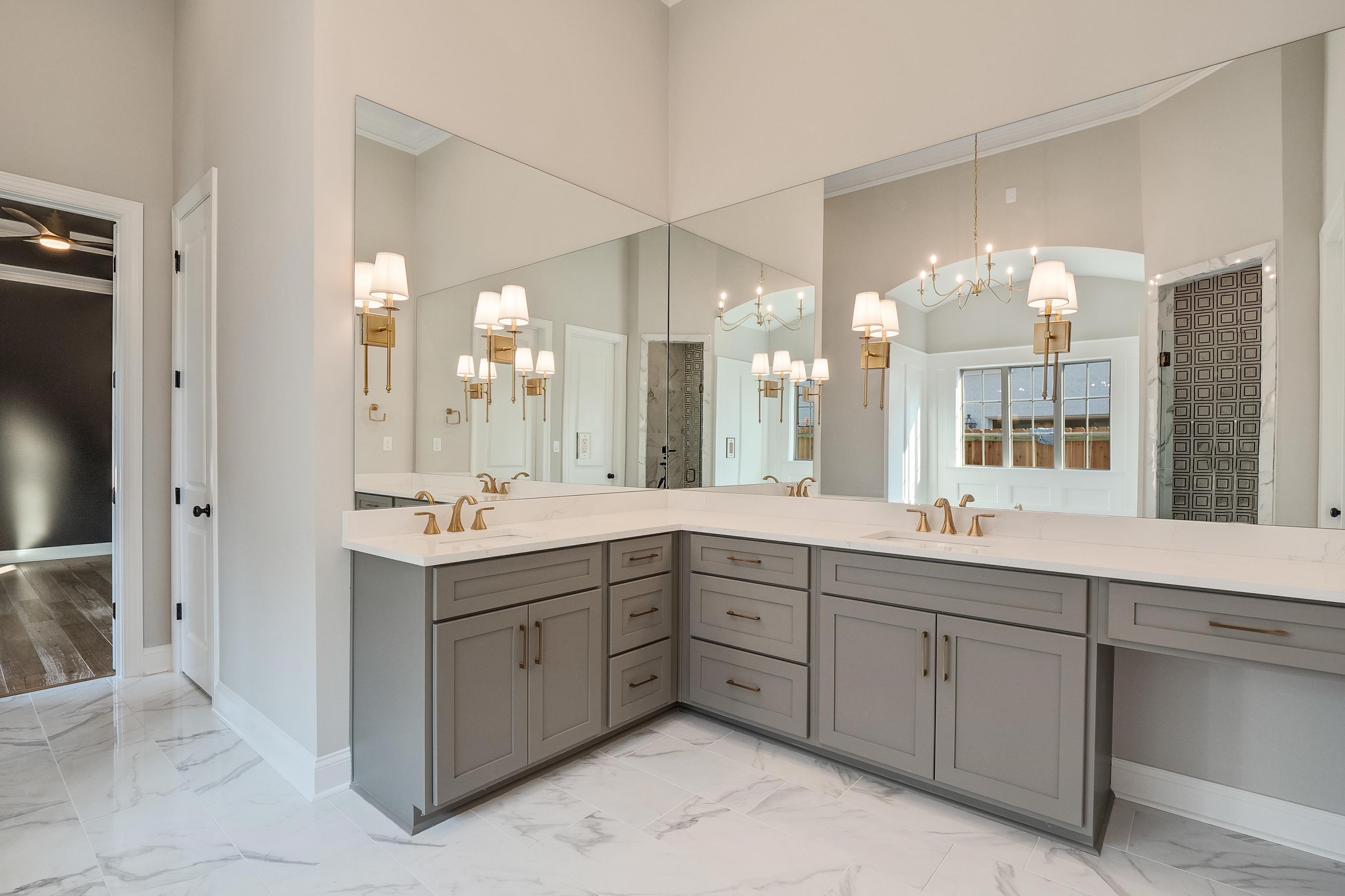 237 Beckham Drive Collierville, TN 38017 - Photo 19 of 40 Bathroom featuring a sink, marble finish floor, baseboards, and a notable chandelier