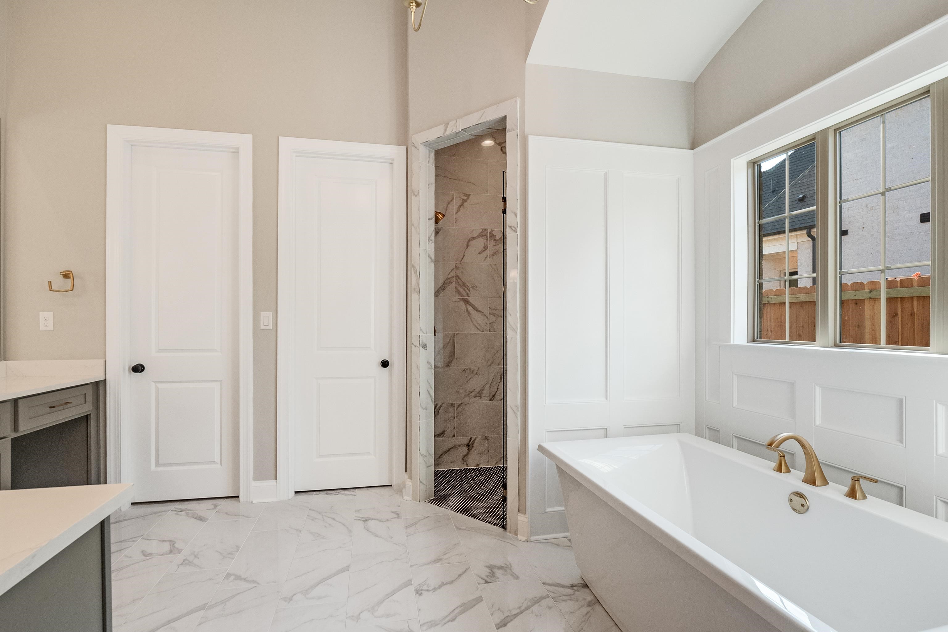 237 Beckham Drive Collierville, TN 38017 - Photo 20 of 40 Full bath featuring marble finish floor, a marble finish shower, a freestanding tub, and vanity