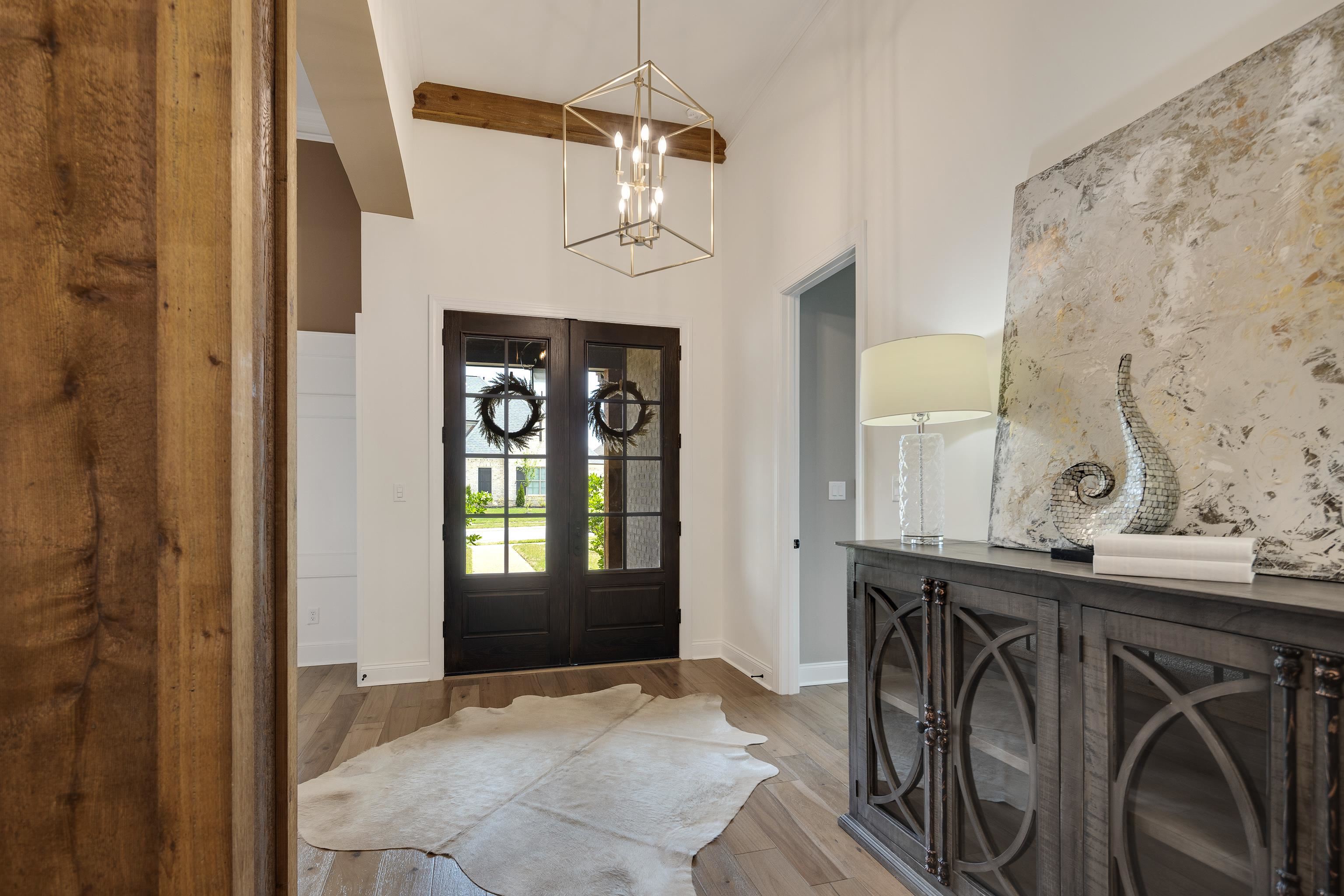 237 Beckham Drive Collierville, TN 38017 - Photo 2 of 40 Foyer with a chandelier, wood finished floors, and baseboards