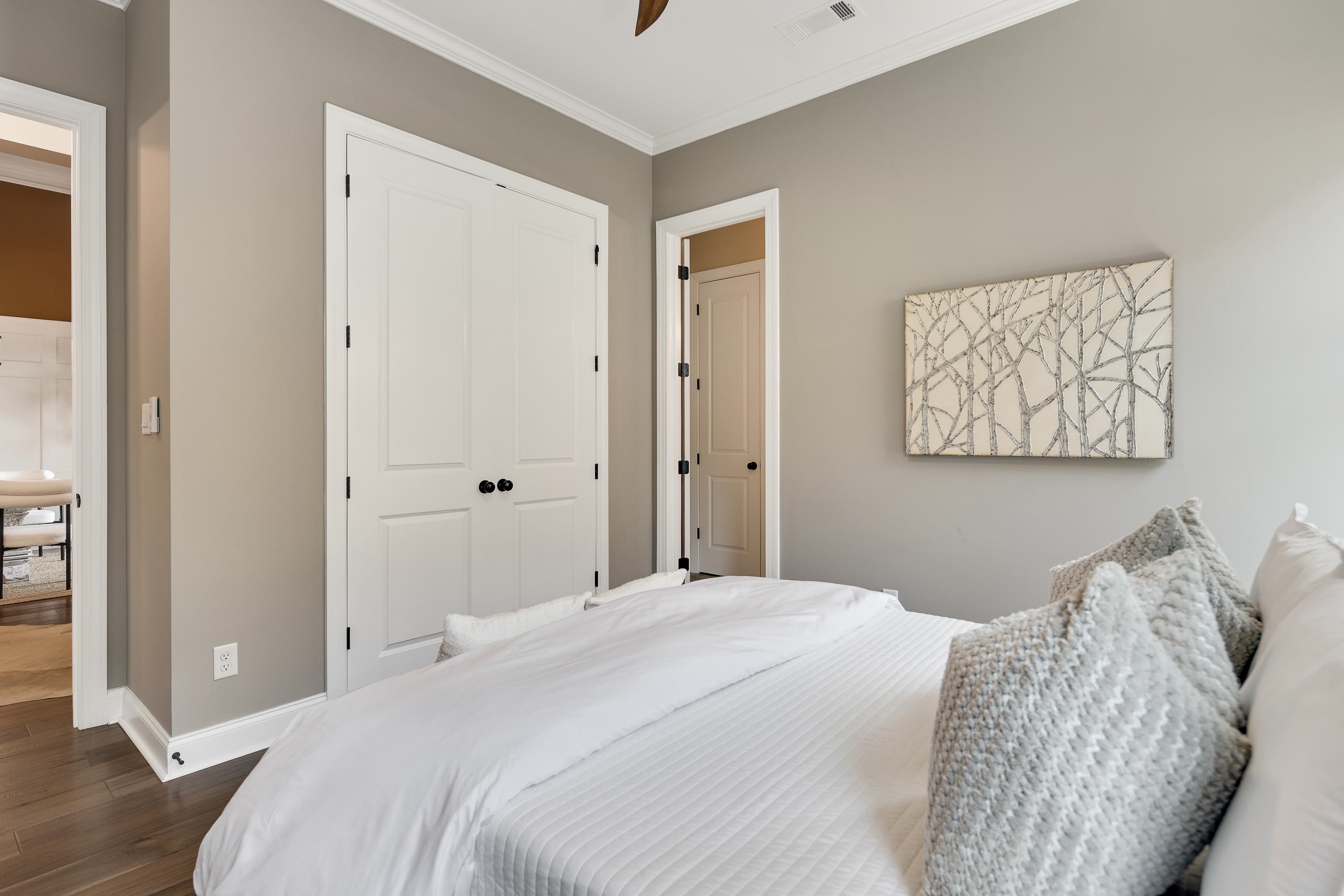 237 Beckham Drive Collierville, TN 38017 - Photo 22 of 40 Bedroom with dark wood-style floors, a closet, ornamental molding, baseboards, and a ceiling fan