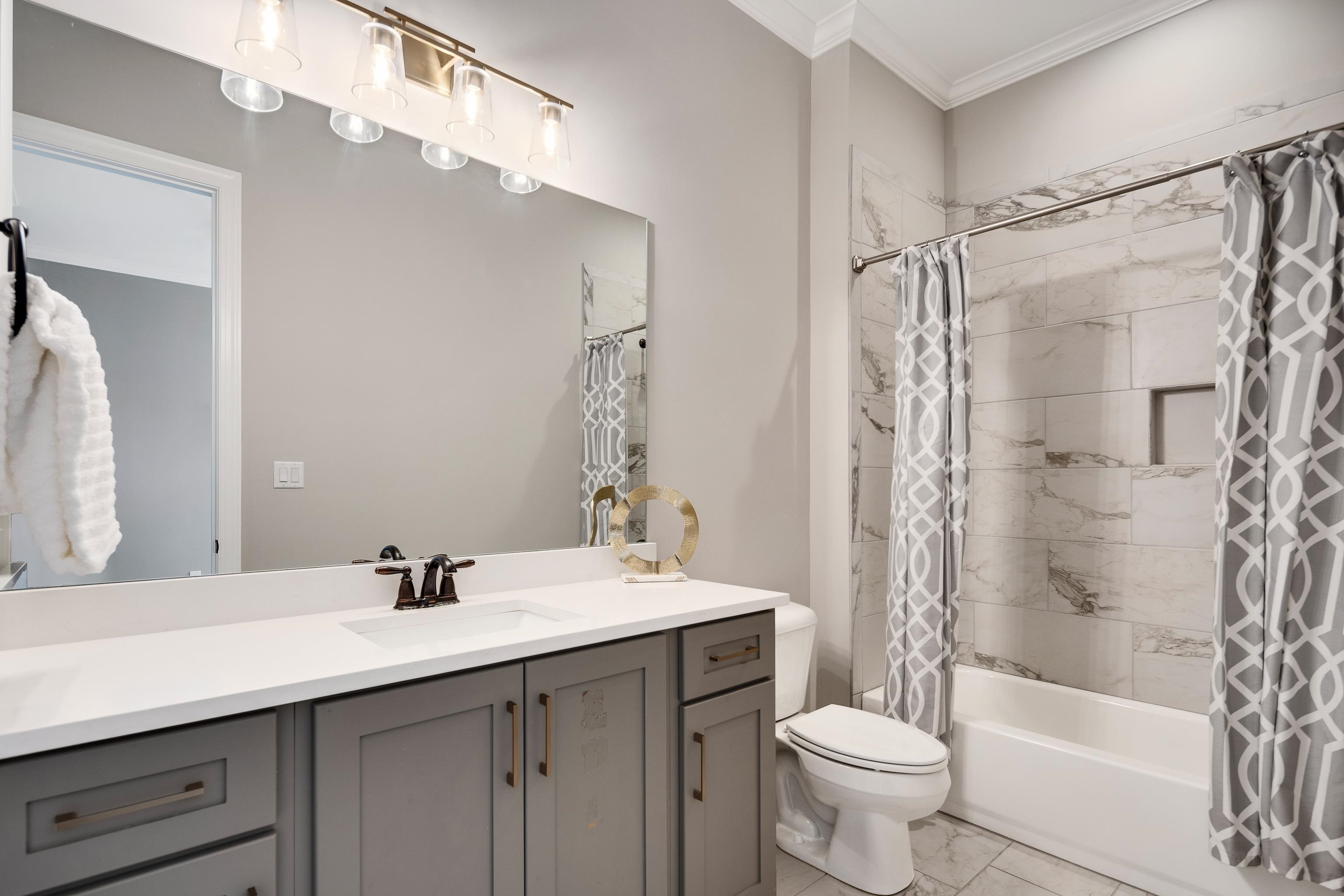 237 Beckham Drive Collierville, TN 38017 - Photo 23 of 40 Full bath with ornamental molding, marble finish flooring, shower / bathtub combination with curtain, toilet, and vanity