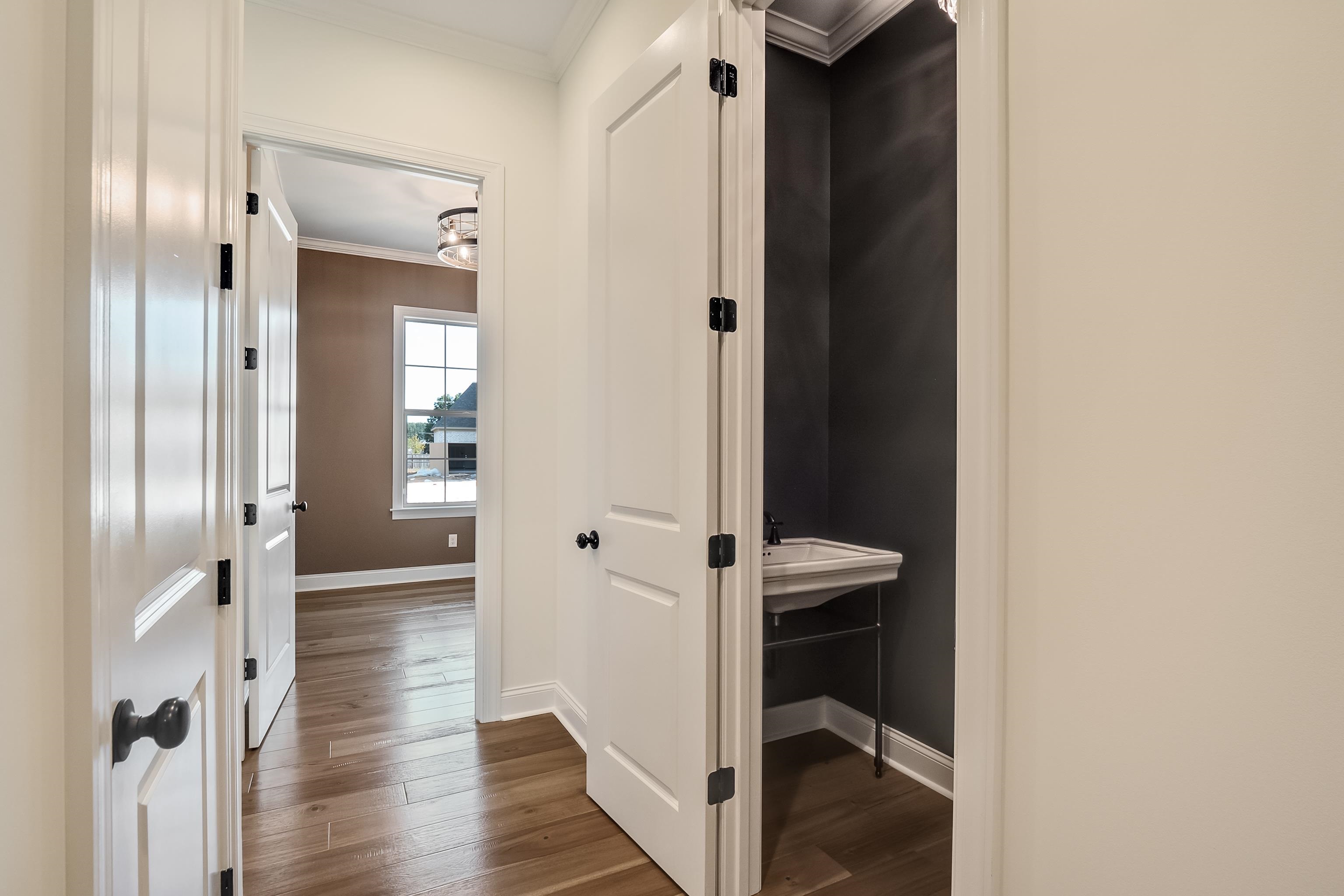 237 Beckham Drive Collierville, TN 38017 - Photo 24 of 40 Corridor with ornamental molding, dark wood-style flooring, and baseboards